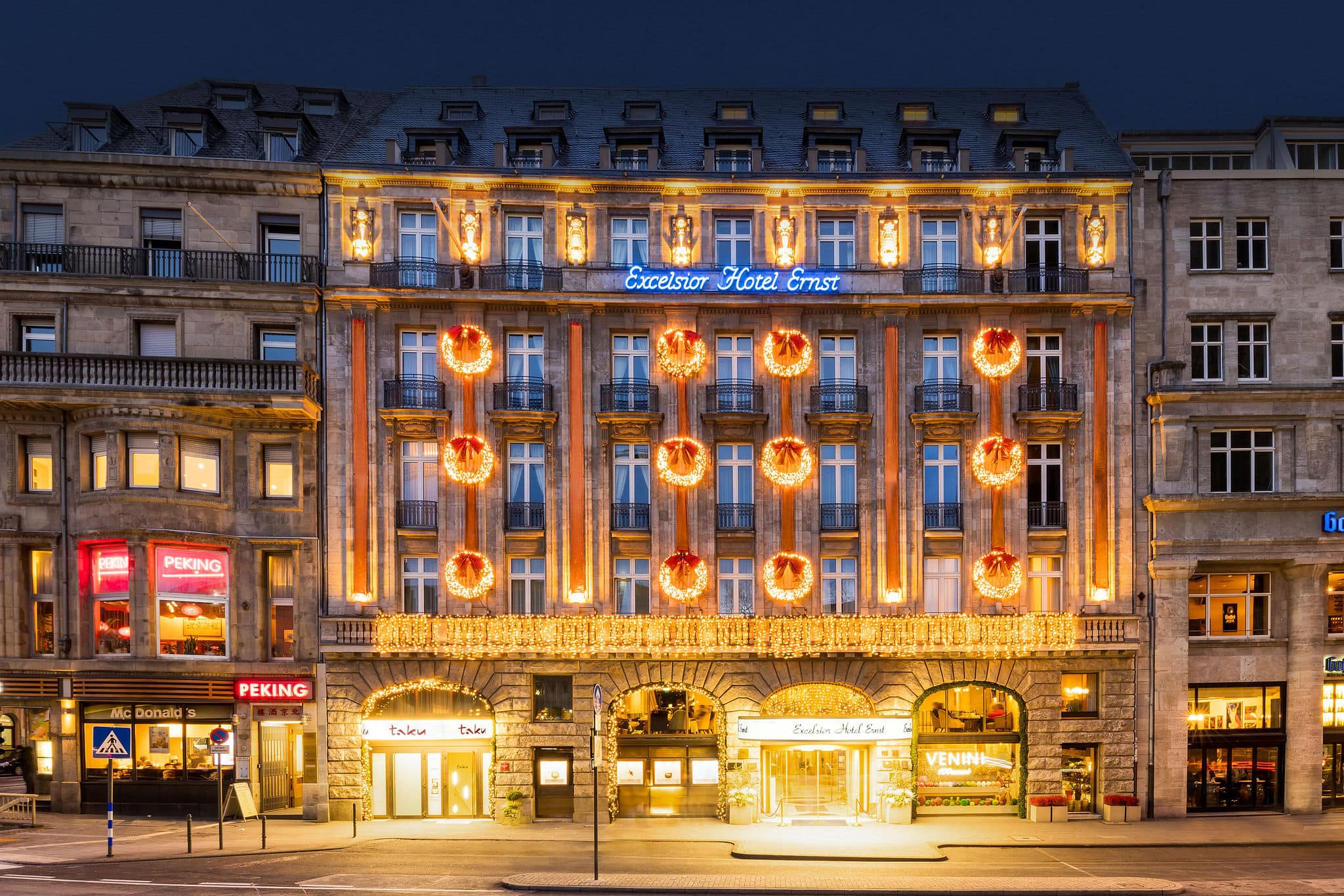 Festively decorated and illuminated facade of the Excelsior Hotel Ernst